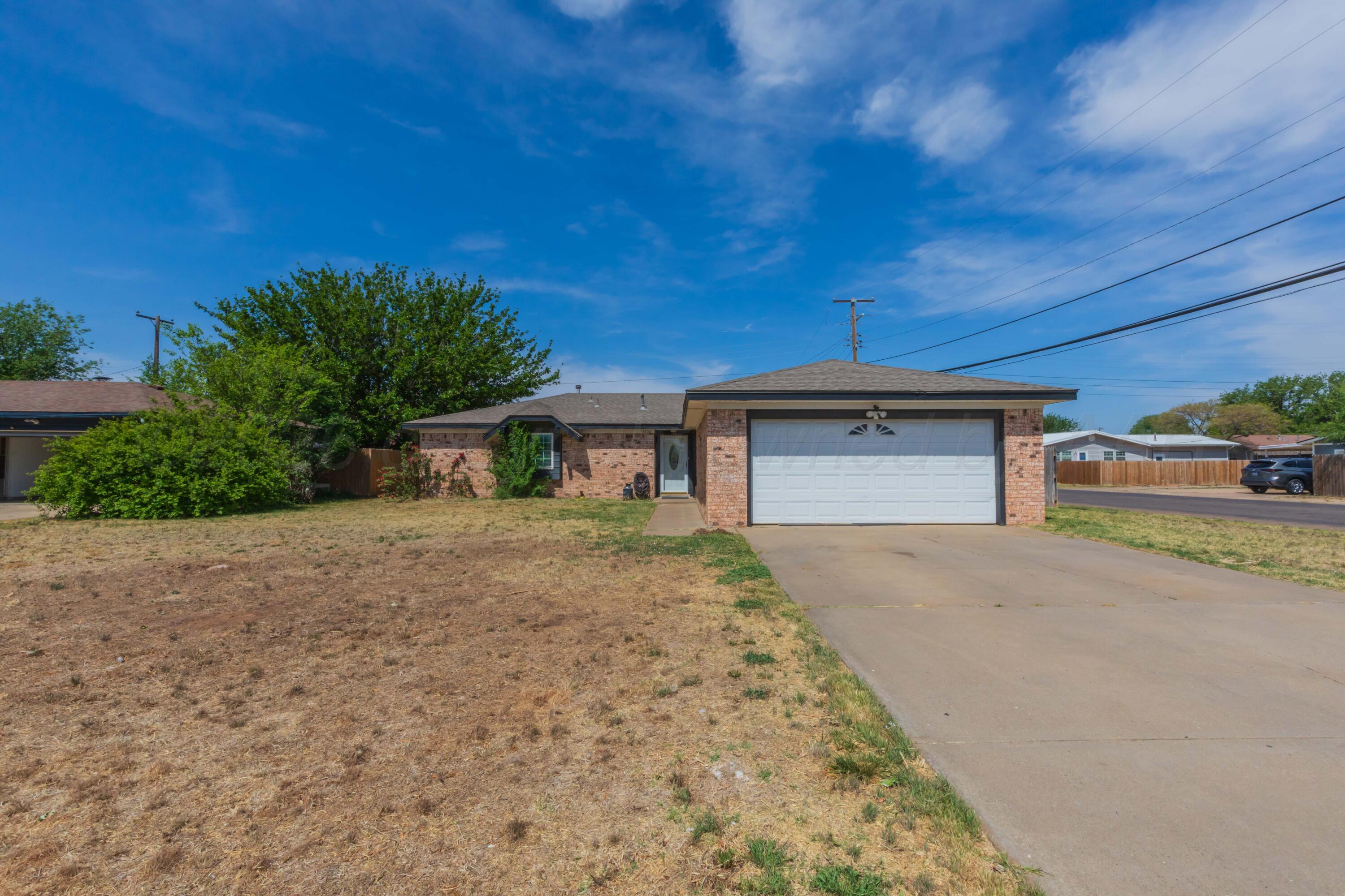 4800 South Austin Street Amarillo, TX 79110 - Photo 5 of 29 a front view of a house with a yard and garage