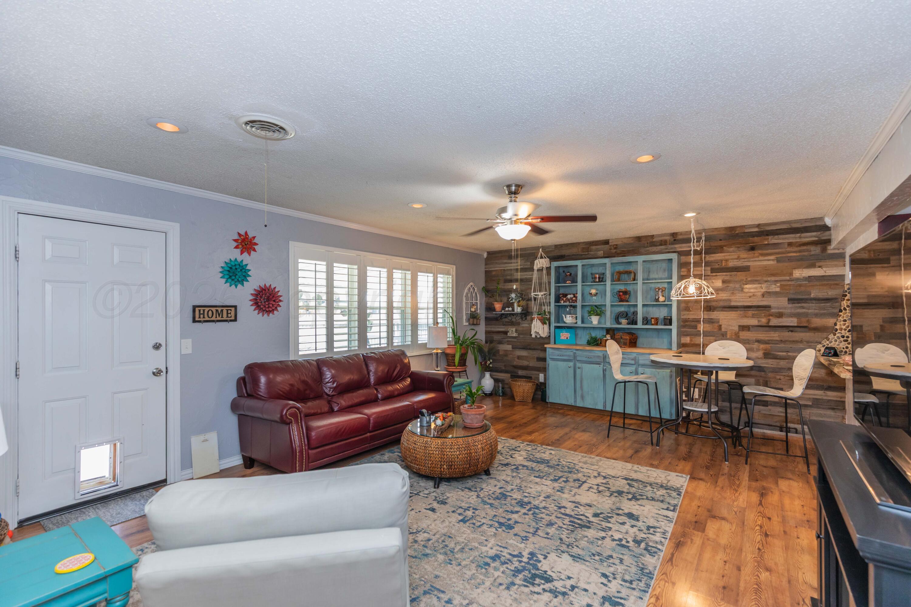4800 South Austin Street Amarillo, TX 79110 - Photo 7 of 29 a living room with furniture a rug and kitchen view
