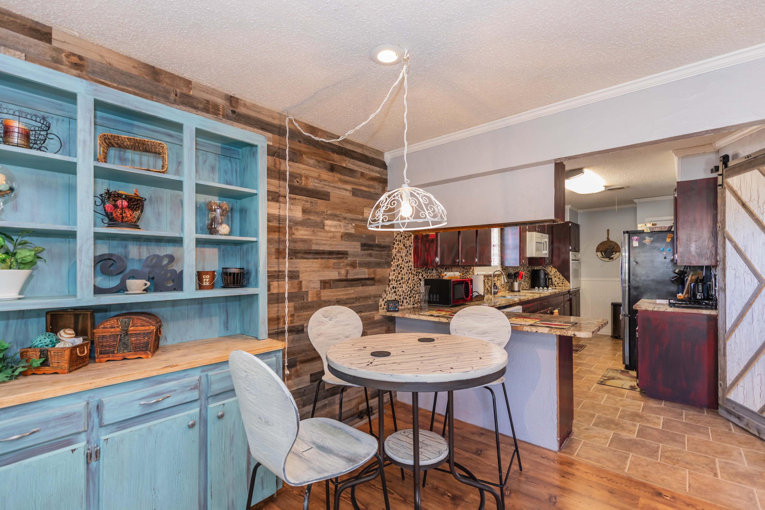 4800 South Austin Street Amarillo, TX 79110 - Photo 9 of 29 a kitchen with a dining table cabinets and a dining table