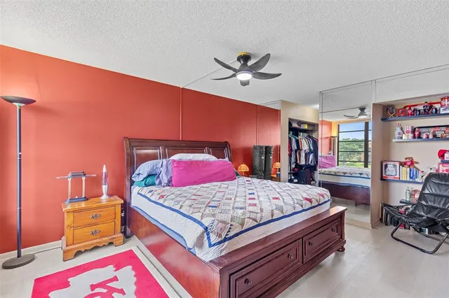 a bedroom with a bed and a dresser in it