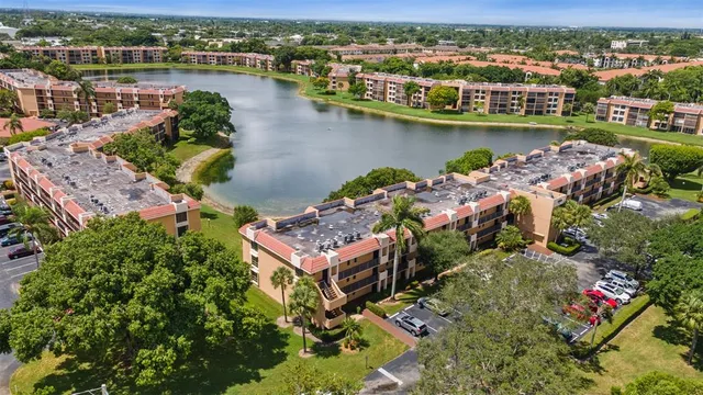 an aerial view of lake and residential houses with outdoor space