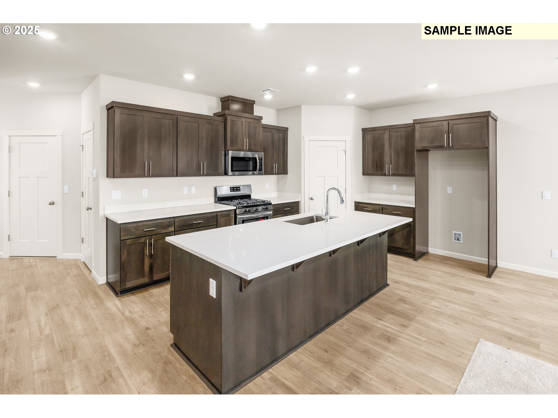 1472 Southeast Logan Parkway Albany, OR 97322 - Photo 5 of 23 a kitchen with a sink counter top space and stainless steel appliances