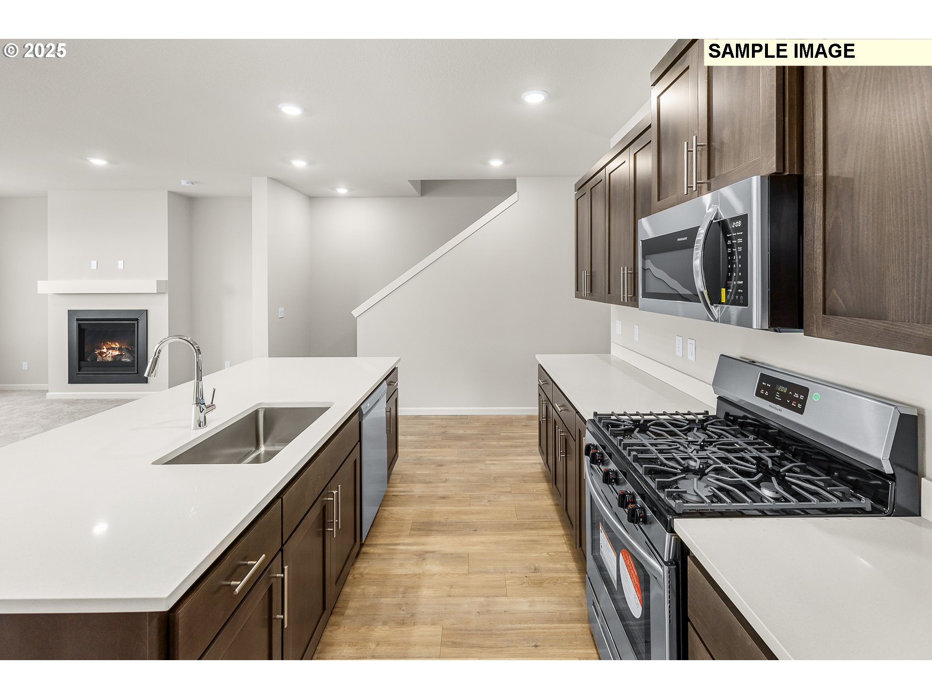 1472 Southeast Logan Parkway Albany, OR 97322 - Photo 7 of 23 a kitchen with stainless steel appliances kitchen island granite countertop a stove and a sink
