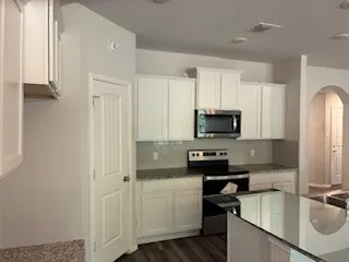 a kitchen with a sink stove and refrigerator