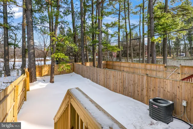 a view of a swimming pool with an outdoor seating and a shower