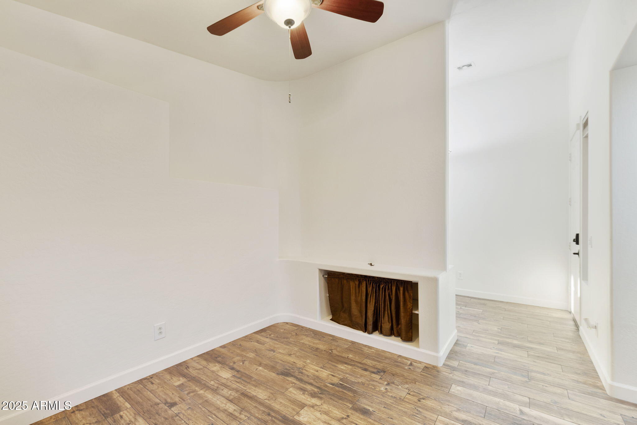 2129 South Compton Mesa, AZ 85209 - Photo 18 of 28 an empty room with a ceiling fan and wooden floor