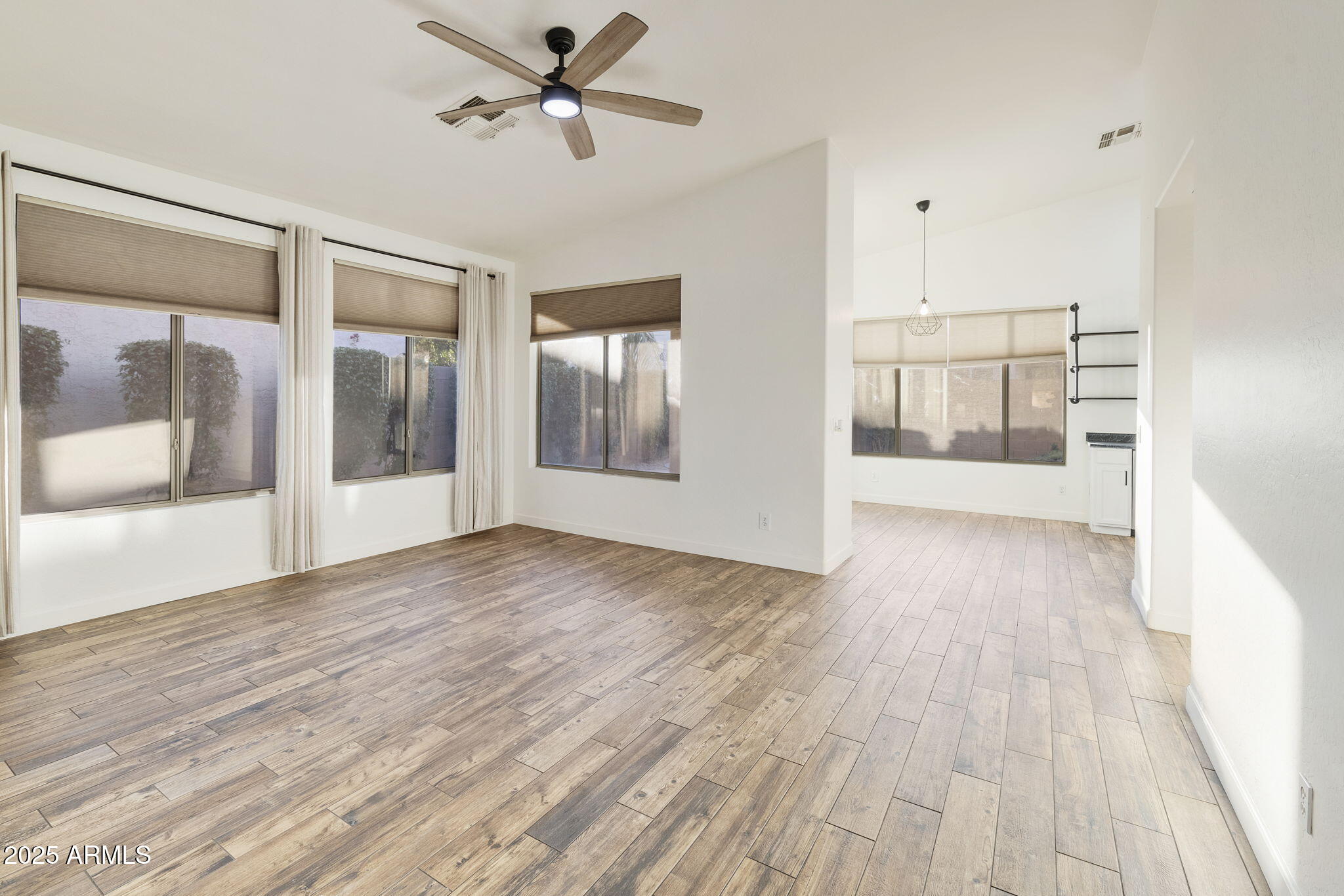 2129 South Compton Mesa, AZ 85209 - Photo 4 of 28 a view of empty room with wooden floor and fan