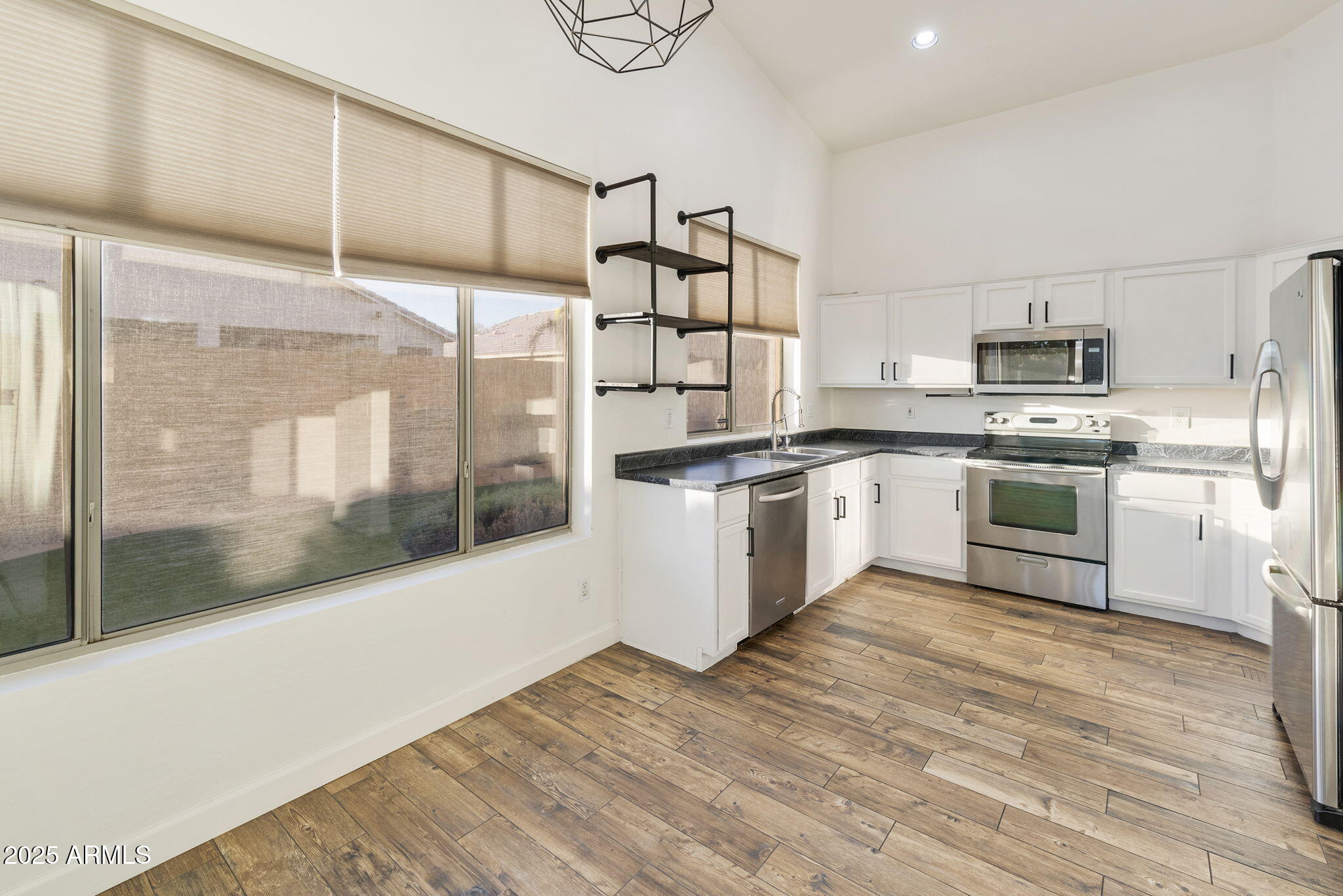 2129 South Compton Mesa, AZ 85209 - Photo 6 of 28 a kitchen with stainless steel appliances granite countertop a stove and cabinets