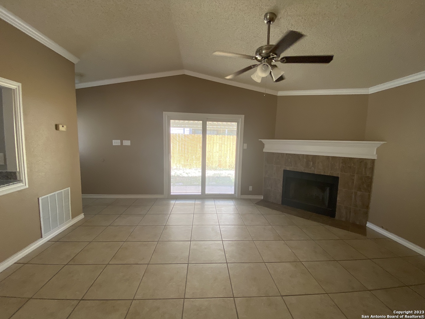 8406 Forest Ridge Drive San Antonio, TX 78239 - Photo 13 of 23 a view of an empty room with a fireplace and a window