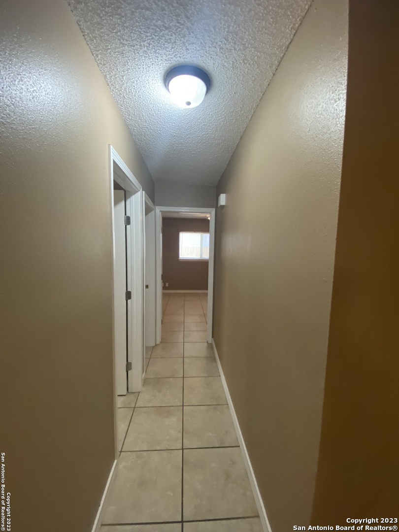 8406 Forest Ridge Drive San Antonio, TX 78239 - Photo 22 of 23 a view of hallway with a window and a mirror
