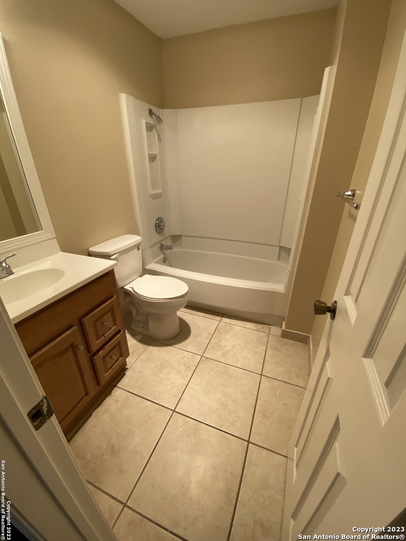 8406 Forest Ridge Drive San Antonio, TX 78239 - Photo 8 of 23 a bathroom with a sink a toilet and shower