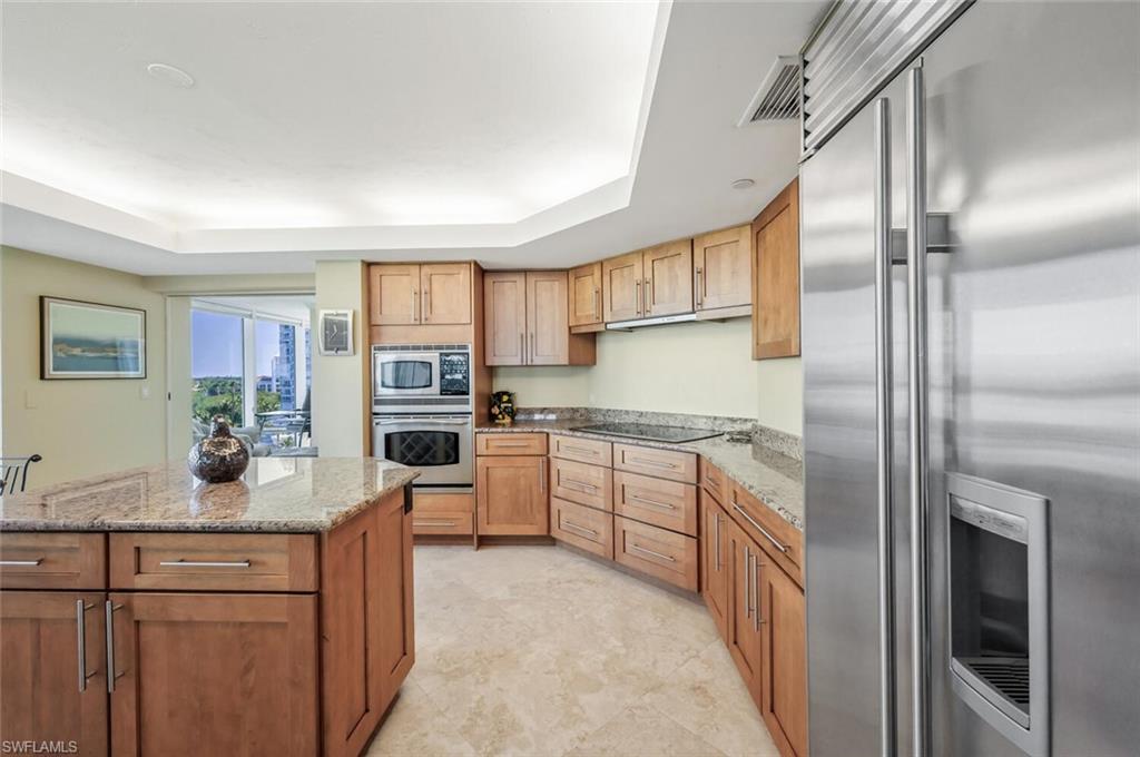 20 Seagate Drive, Unit 803 Naples, FL 34103 - Photo 11 of 44 a kitchen with stainless steel appliances granite countertop a refrigerator sink and stove