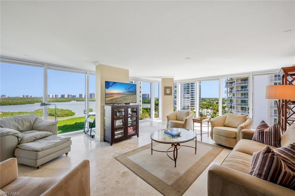 20 Seagate Drive, Unit 803 Naples, FL 34103 - Photo 17 of 44 a living room with furniture fireplace and a view of kitchen