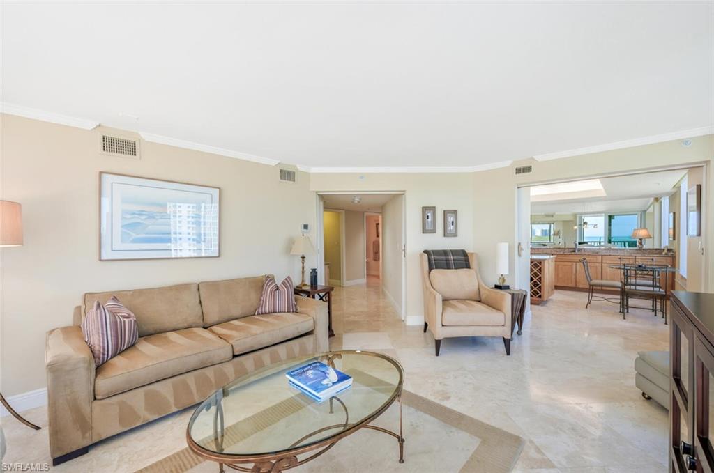 20 Seagate Drive, Unit 803 Naples, FL 34103 - Photo 19 of 44 a living room with furniture and a large window