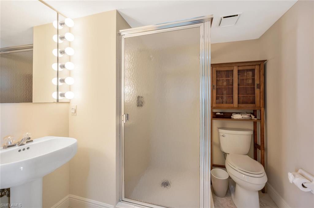 20 Seagate Drive, Unit 803 Naples, FL 34103 - Photo 20 of 44 a bathroom with a shower a toilet and sink