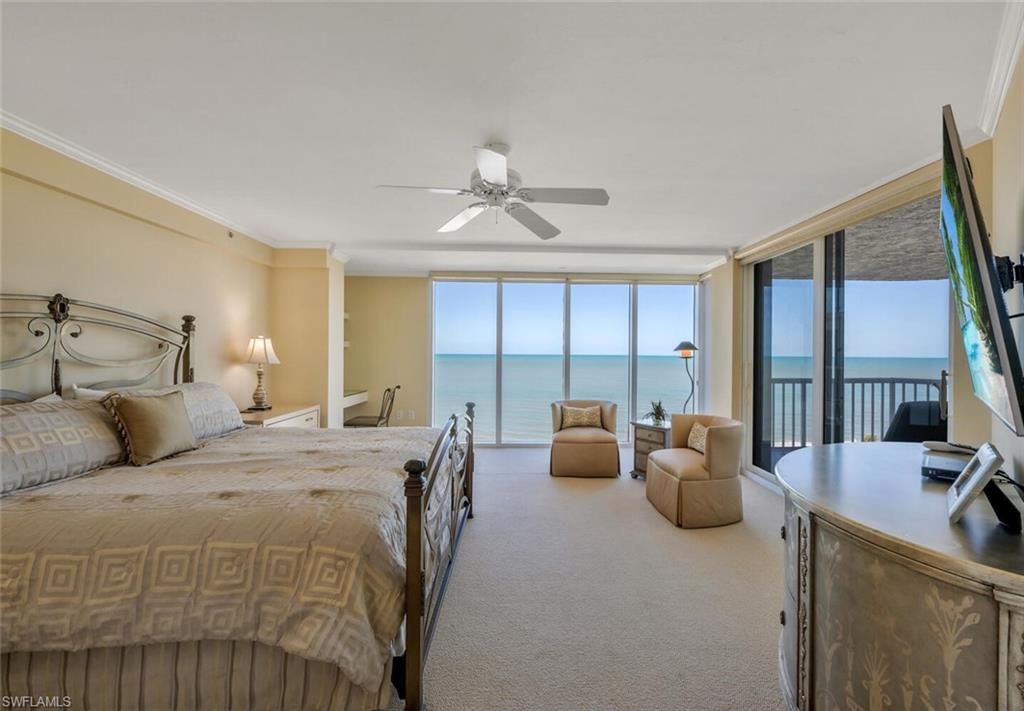 20 Seagate Drive, Unit 803 Naples, FL 34103 - Photo 21 of 44 a bedroom with furniture and a large window