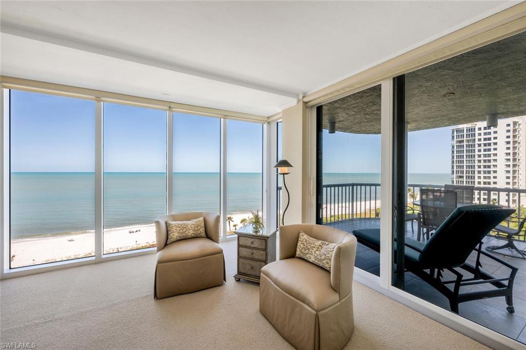 20 Seagate Drive, Unit 803 Naples, FL 34103 - Photo 23 of 44 a living room with furniture and a floor to ceiling window