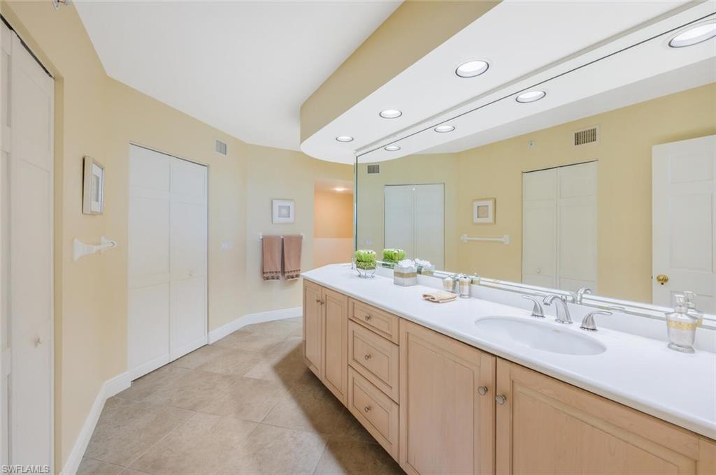 20 Seagate Drive, Unit 803 Naples, FL 34103 - Photo 25 of 44 a spacious bathroom with a double vanity sink a mirror and shower