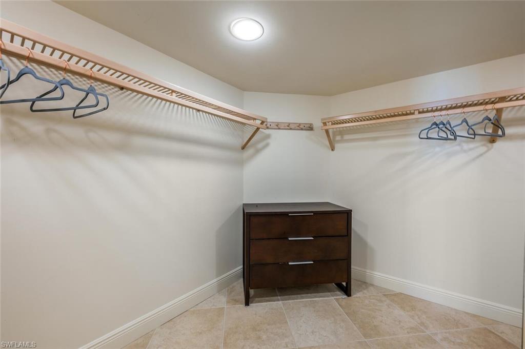 20 Seagate Drive, Unit 803 Naples, FL 34103 - Photo 29 of 44 a room with a air conditioner and a ceiling fan