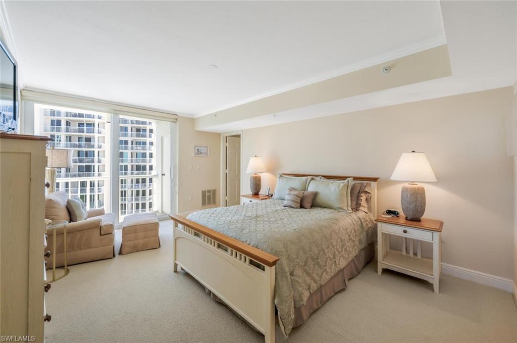 20 Seagate Drive, Unit 803 Naples, FL 34103 - Photo 30 of 44 a spacious bedroom with a bed and a large window