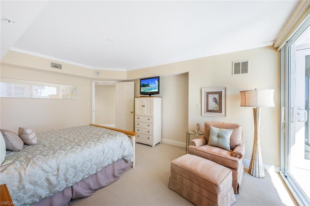 20 Seagate Drive, Unit 803 Naples, FL 34103 - Photo 31 of 44 a bedroom with a bed couch and a window