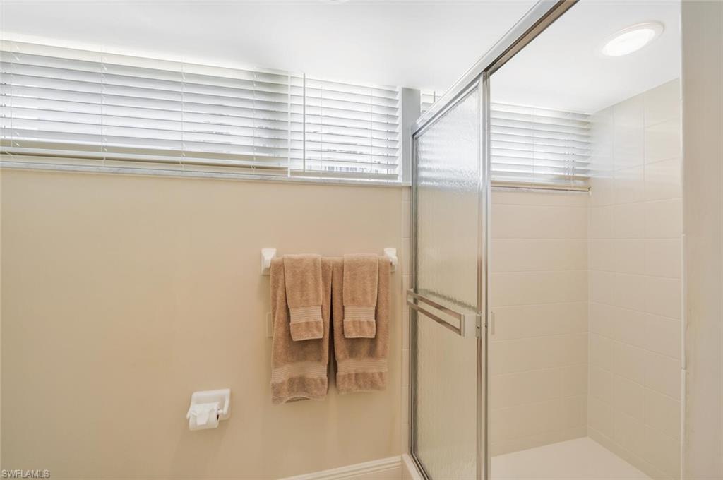 20 Seagate Drive, Unit 803 Naples, FL 34103 - Photo 33 of 44 a bathroom with a bathtub and a shower