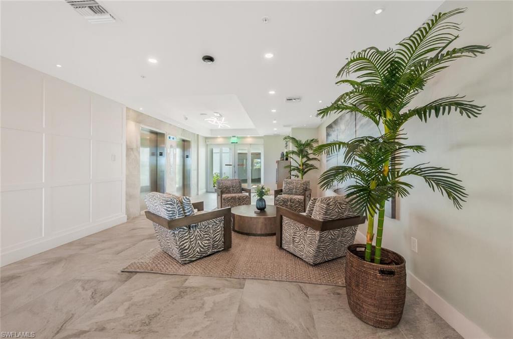20 Seagate Drive, Unit 803 Naples, FL 34103 - Photo 43 of 44 a living room with furniture and a potted plant