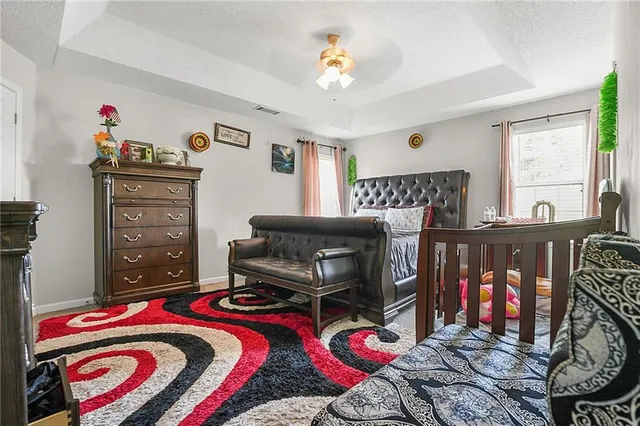 a bedroom with furniture and a chandelier