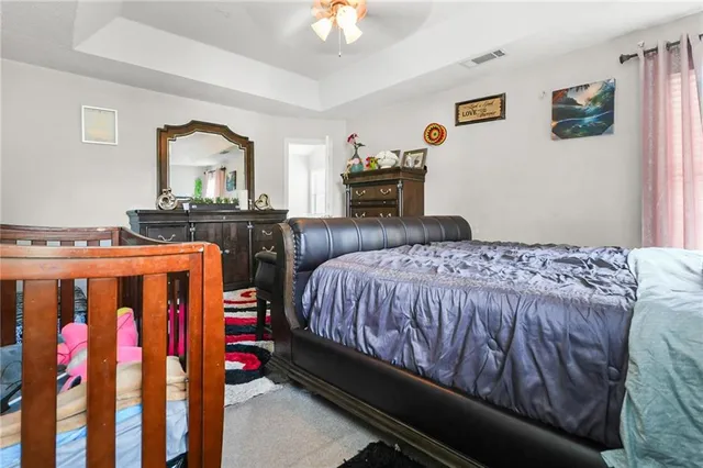 a bedroom with a bed and a chandelier
