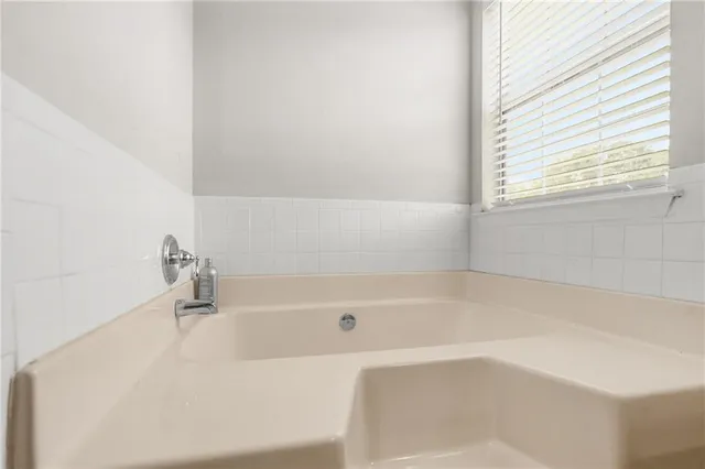 a white bath tub sitting next to a window