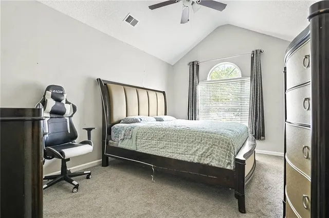 a bedroom with a bed and a mirror