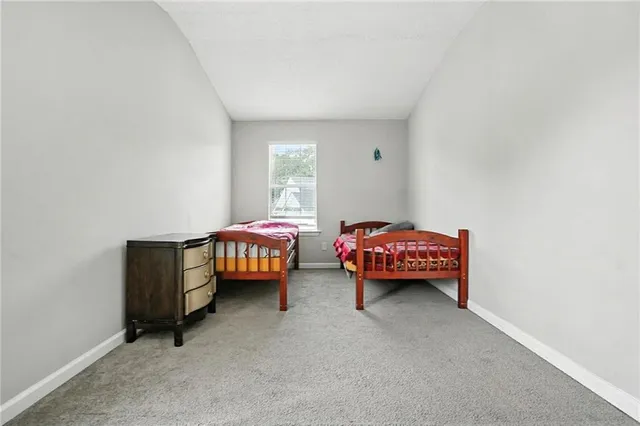 a bedroom with two beds and a chandelier