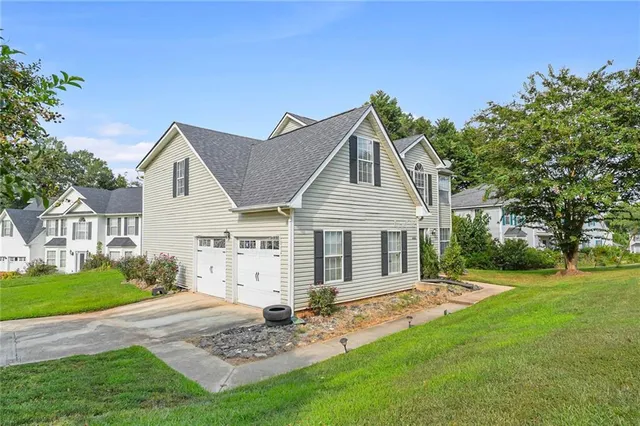 a front view of a house with a garden
