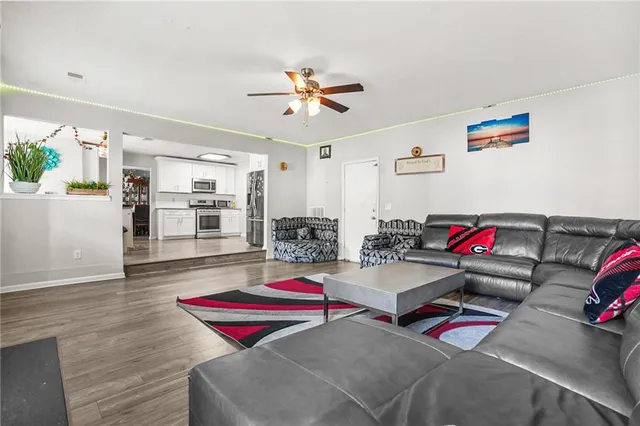 a room with furniture and a view of kitchen