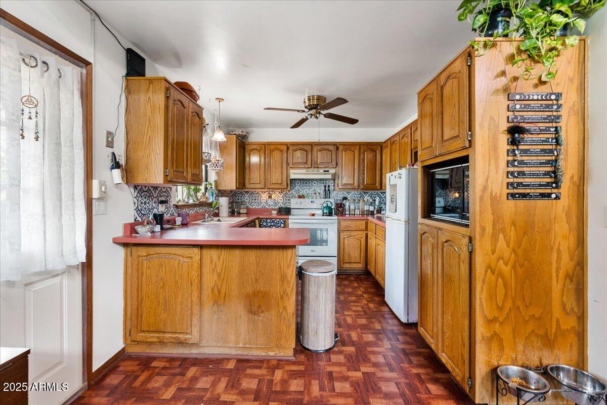 17040 Bowstring Road Munds Park, AZ 86017 - Photo 11 of 18 a kitchen with stainless steel appliances granite countertop a refrigerator and a sink
