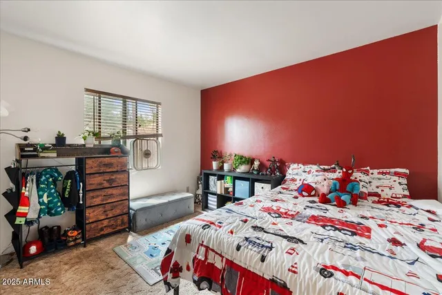 a bedroom with a bed and a dresser in it