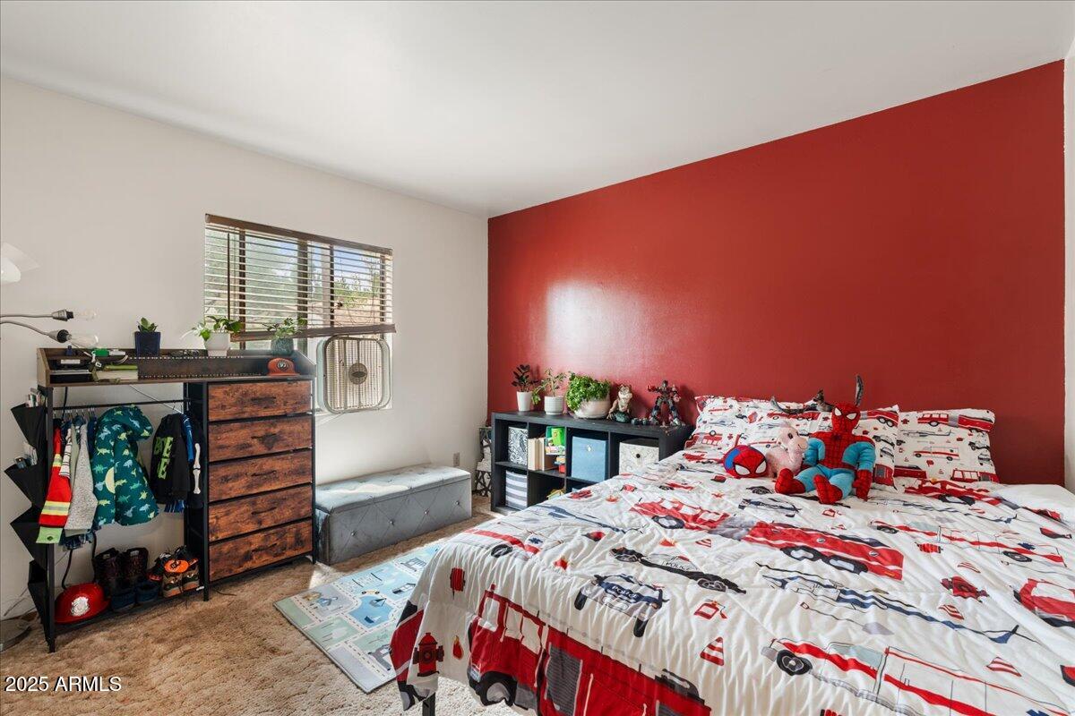 17040 Bowstring Road Munds Park, AZ 86017 - Photo 12 of 18 a bedroom with a bed and a dresser in it
