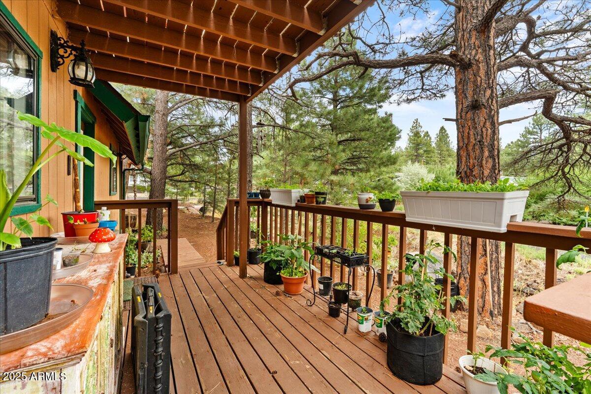 17040 Bowstring Road Munds Park, AZ 86017 - Photo 3 of 18 a view of balcony with wooden floor and seating space