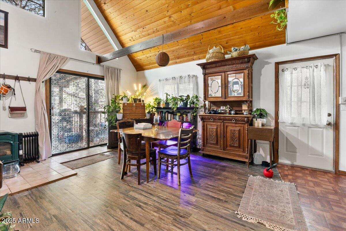 17040 Bowstring Road Munds Park, AZ 86017 - Photo 5 of 18 a view of a dining room with furniture window and wooden floor