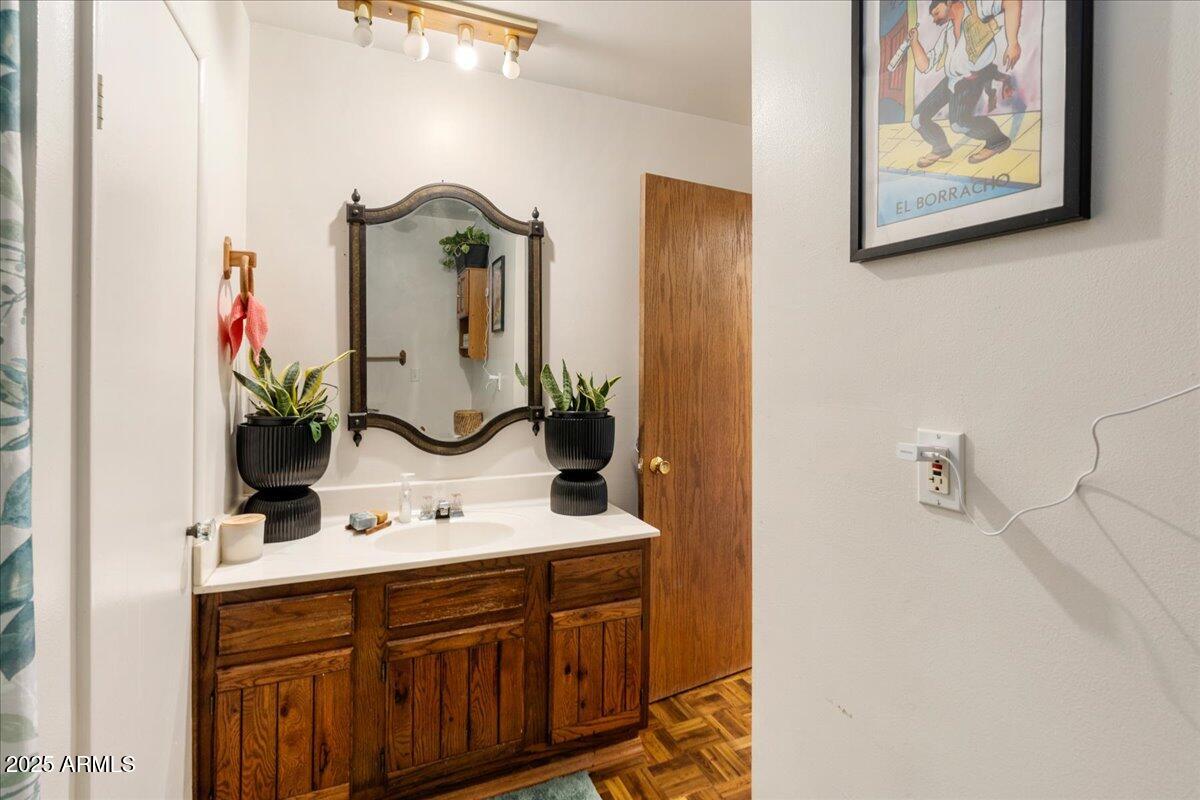 17040 Bowstring Road Munds Park, AZ 86017 - Photo 10 of 18 a bathroom with a sink and a mirror