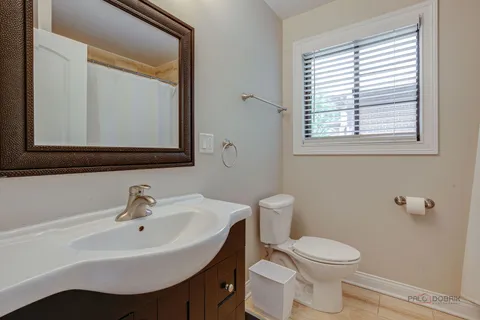 a white toilet sitting next to a bathroom sink