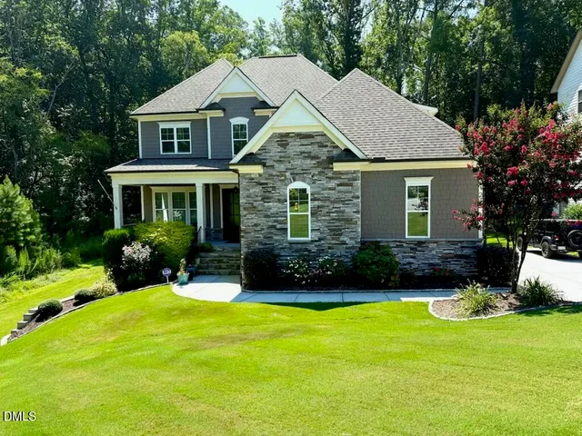a view of a house with a yard and plants