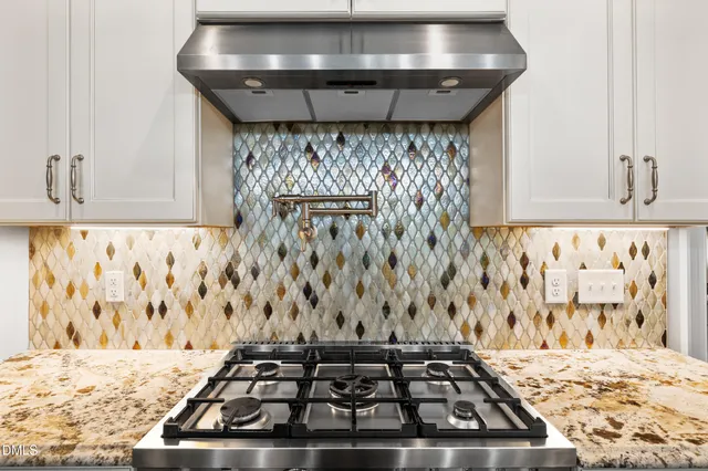 a kitchen with granite countertop a refrigerator and a stove