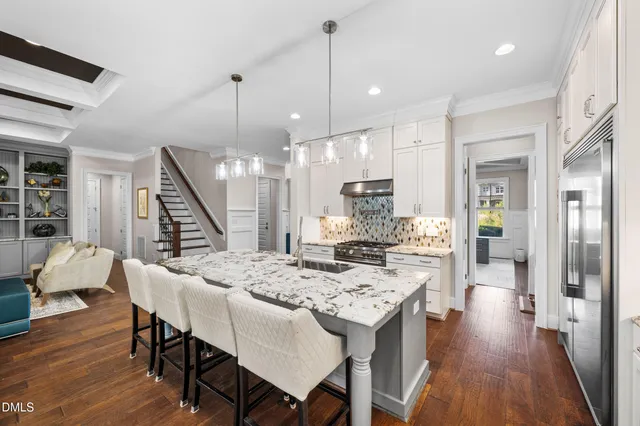 a open kitchen with a sink a counter top space and stainless steel appliances