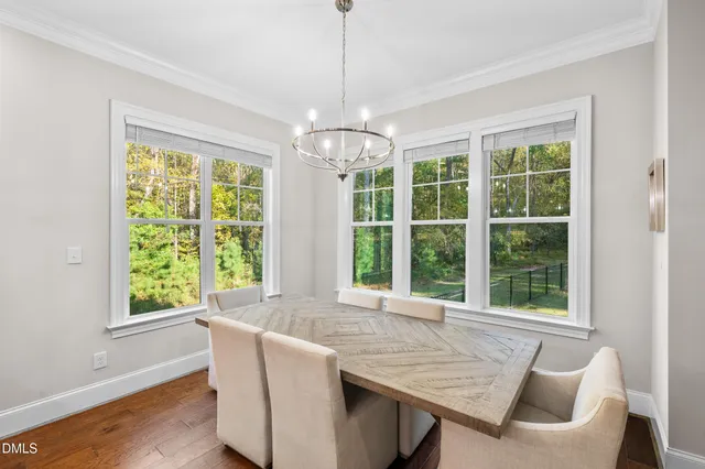 a kitchen with stainless steel appliances granite countertop a stove refrigerator and wooden floor