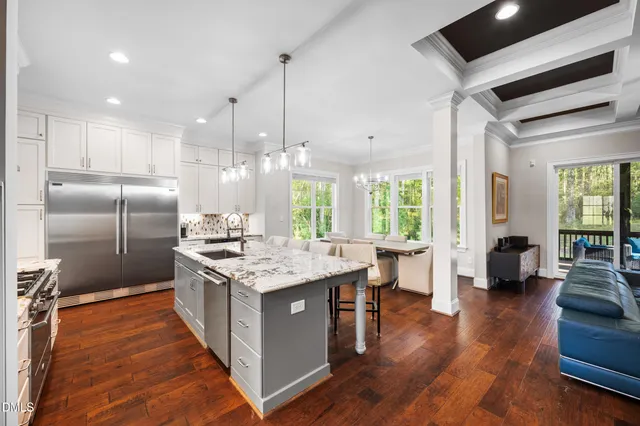 a living room with fireplace furniture and a large window