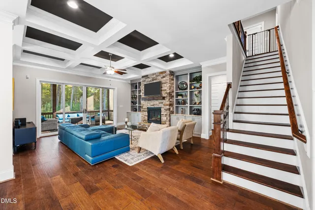 a living room with furniture large window and fireplace