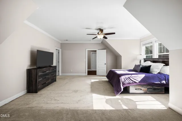 a living room with furniture a flat screen tv and a window