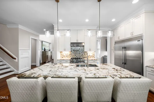 a view of a kitchen with granite countertop cabinets stainless steel appliances and a wooden floor
