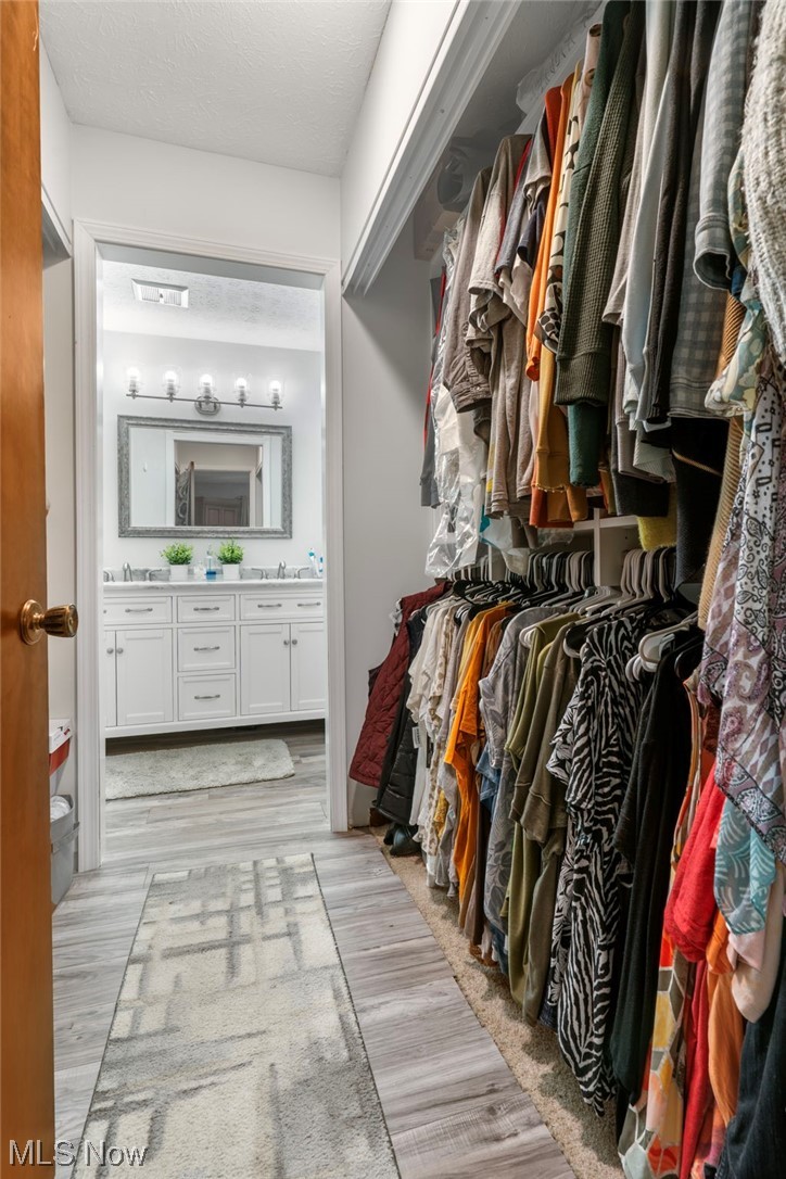 5722 Wiclif Road Northeast Canton, OH 44721 - Photo 21 of 35 Walk in closet featuring light hardwood floors